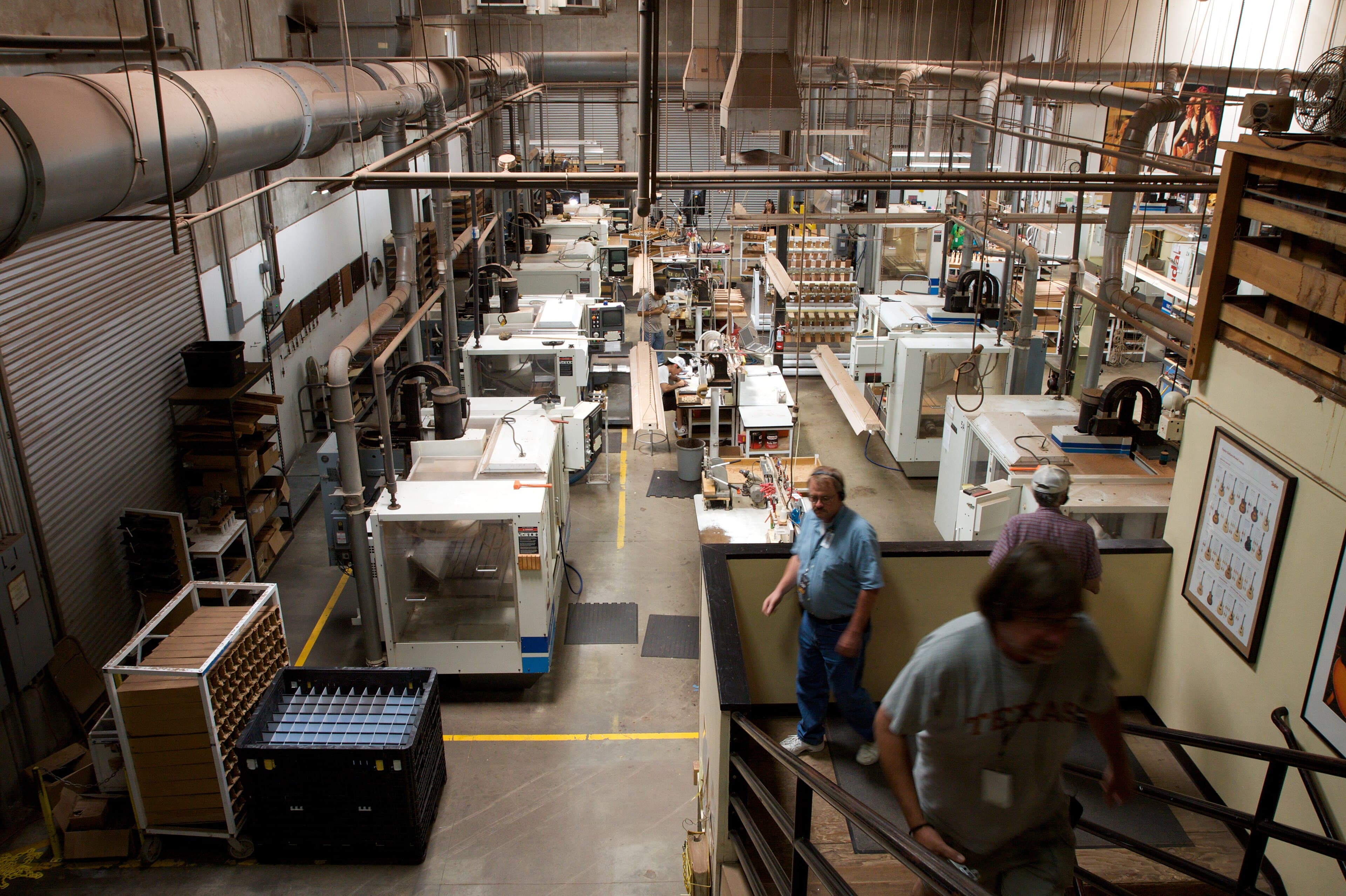 CNC milling machines cutting components in a production factory